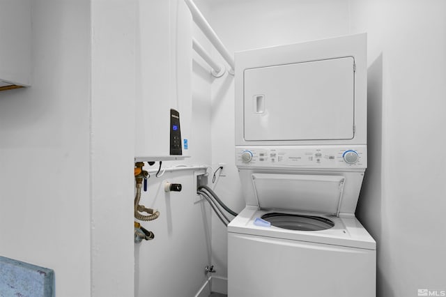 laundry area featuring stacked washer and clothes dryer