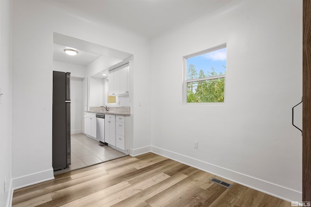 interior space with light hardwood / wood-style flooring and sink