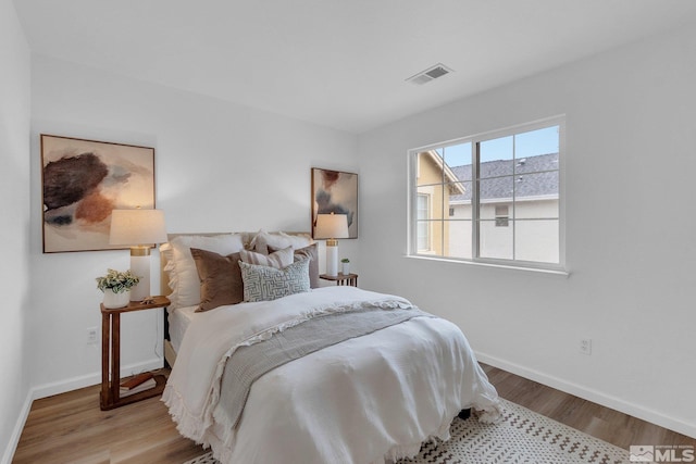 bedroom with light hardwood / wood-style floors