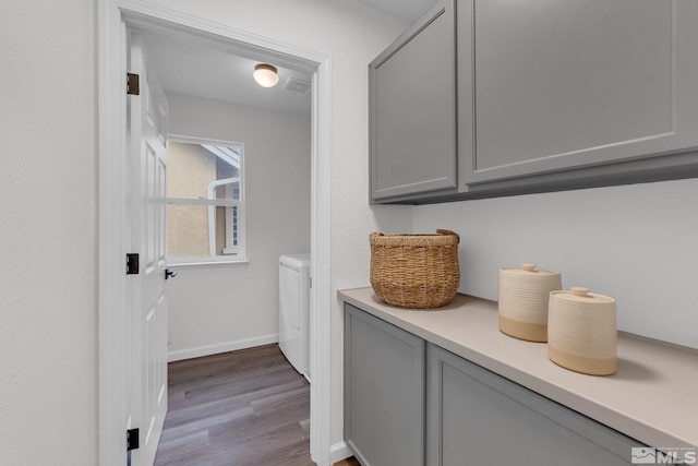 laundry room featuring hardwood / wood-style floors and washing machine and dryer