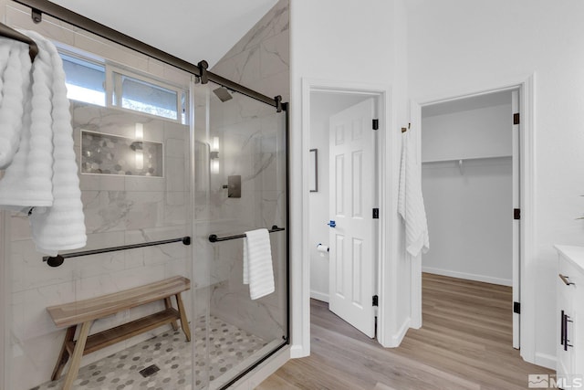 bathroom with vanity, wood-type flooring, and a shower with shower door