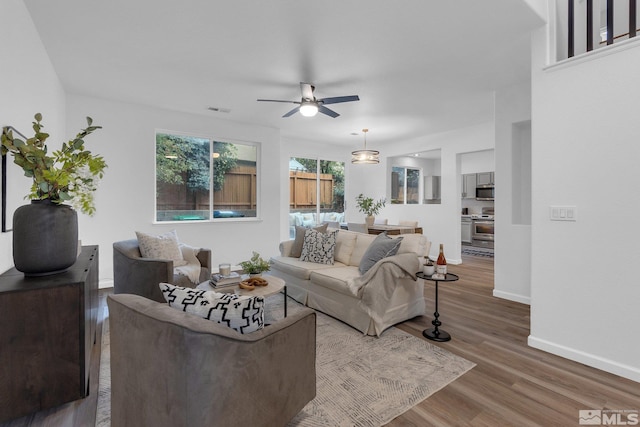 living room with hardwood / wood-style floors and ceiling fan