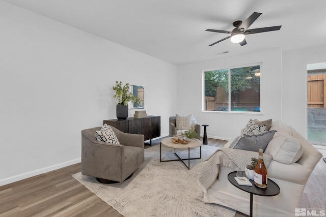 living room with ceiling fan and hardwood / wood-style floors