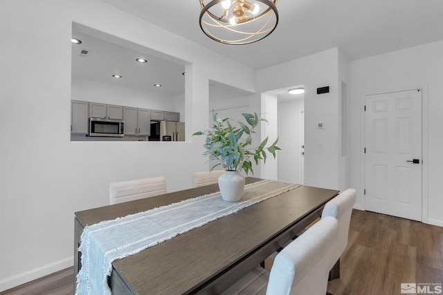 dining space featuring a chandelier and dark hardwood / wood-style flooring