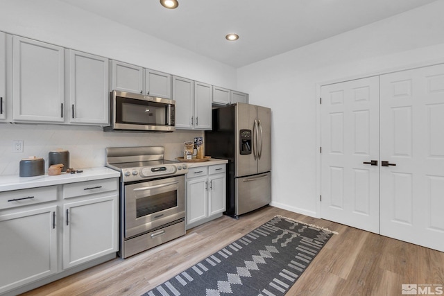 kitchen featuring appliances with stainless steel finishes and light hardwood / wood-style floors