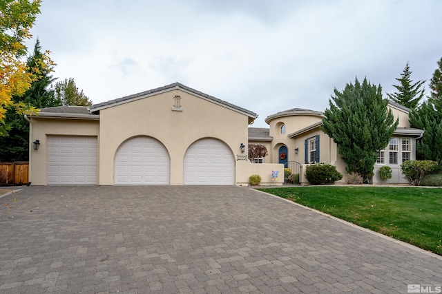 view of front of home with a front yard and a garage