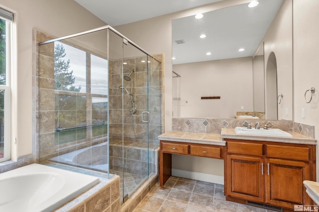 bathroom featuring vanity, independent shower and bath, and tile patterned flooring