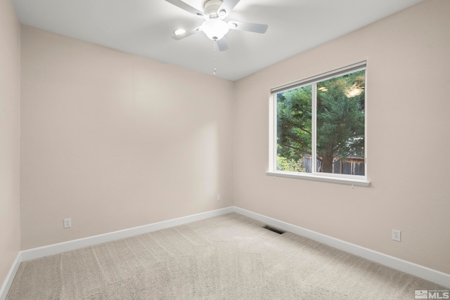 empty room featuring light carpet and ceiling fan