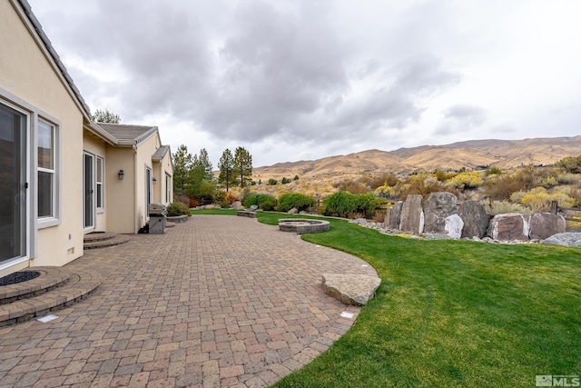 exterior space featuring a mountain view and a patio area