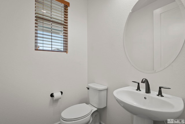 bathroom with toilet and sink