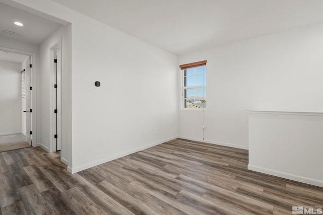 spare room with dark hardwood / wood-style floors