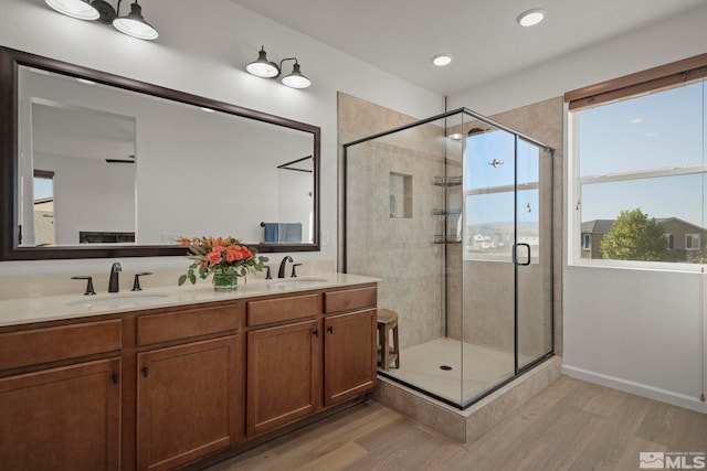 bathroom featuring vanity, hardwood / wood-style flooring, and walk in shower