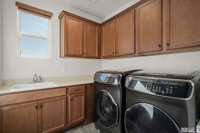 washroom featuring independent washer and dryer, cabinets, and sink