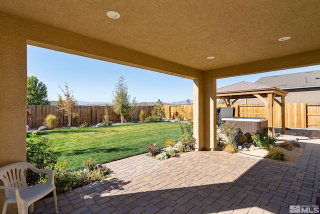 view of patio / terrace with a gazebo and a hot tub