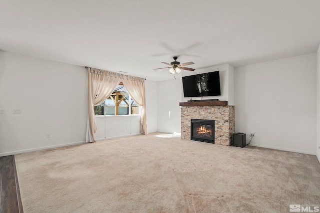 unfurnished living room featuring ceiling fan, carpet, and a fireplace