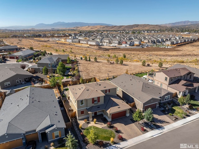 birds eye view of property with a mountain view