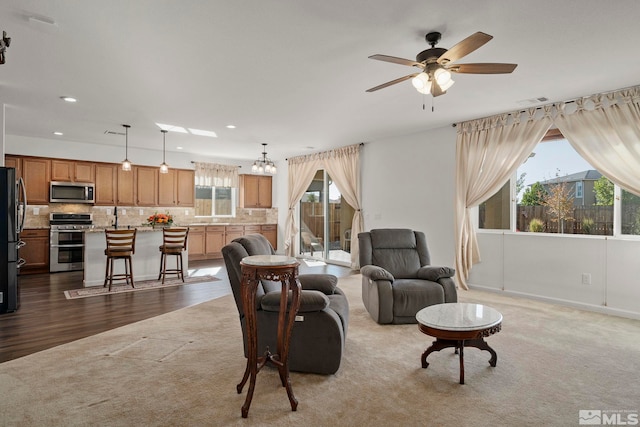 living room with ceiling fan and hardwood / wood-style flooring