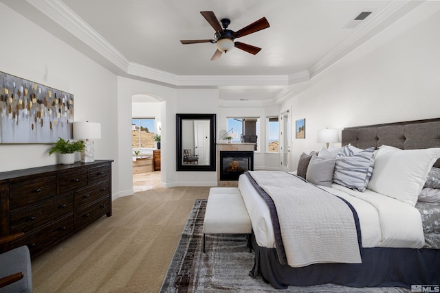 bedroom with ceiling fan, crown molding, and light colored carpet