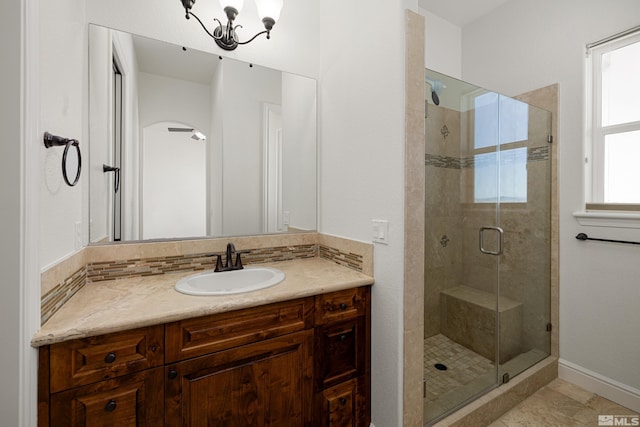 bathroom with vanity, an enclosed shower, and a chandelier