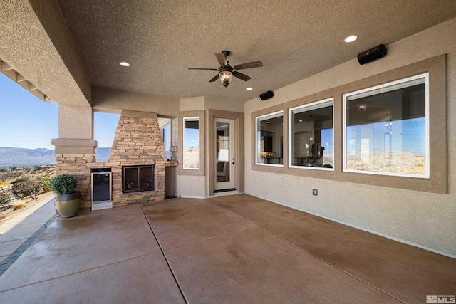 view of patio / terrace featuring a mountain view and ceiling fan