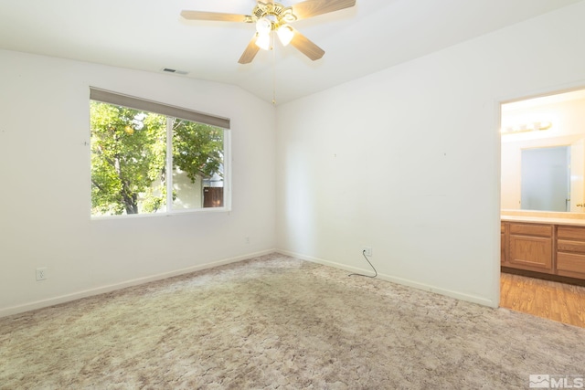 spare room with light carpet, lofted ceiling, and ceiling fan