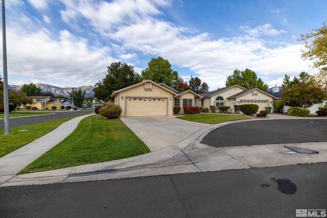 single story home featuring a garage, a front lawn, and a mountain view