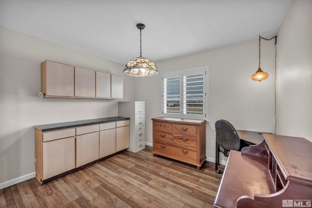 kitchen with light hardwood / wood-style floors, pendant lighting, and light brown cabinets