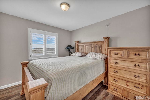 bedroom with dark wood-type flooring