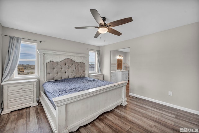 bedroom with connected bathroom, ceiling fan, and hardwood / wood-style floors