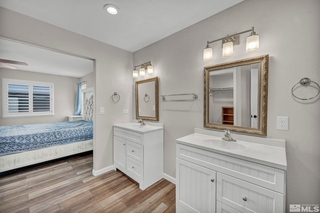 bathroom featuring vanity, ceiling fan, and hardwood / wood-style flooring