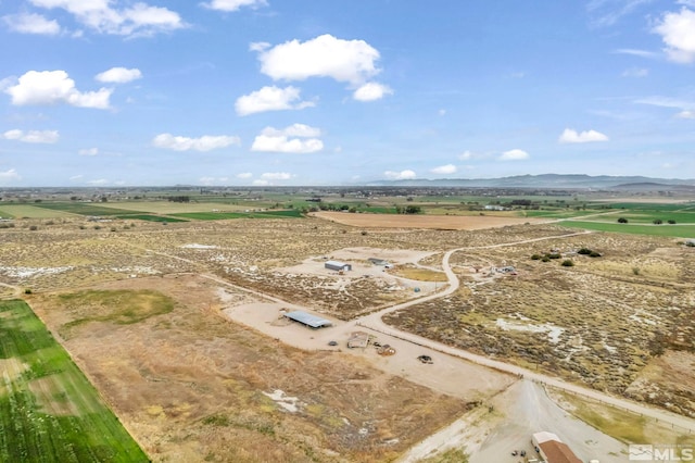 drone / aerial view featuring a mountain view and a rural view