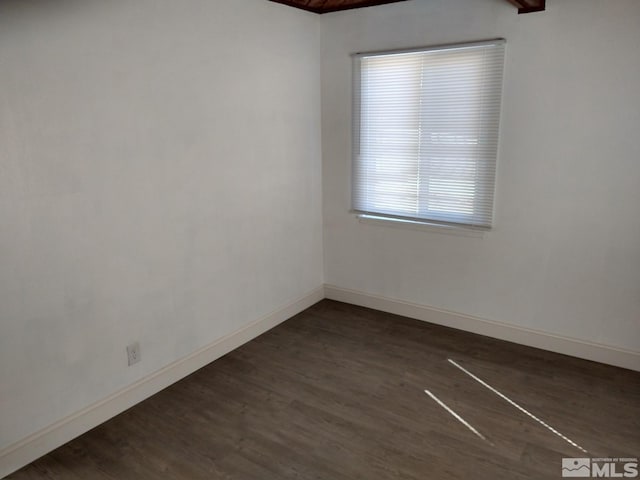 unfurnished room with beamed ceiling, wood ceiling, and dark hardwood / wood-style floors