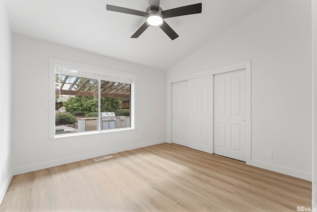 unfurnished bedroom featuring a closet, ceiling fan, vaulted ceiling, and light hardwood / wood-style floors