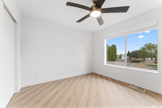 unfurnished room featuring ceiling fan and light wood-type flooring