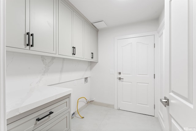 clothes washing area featuring cabinets and hookup for a washing machine