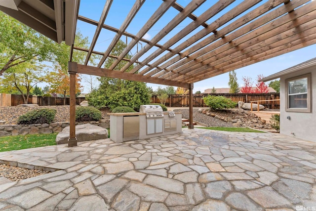 view of patio / terrace featuring area for grilling, a pergola, and exterior kitchen