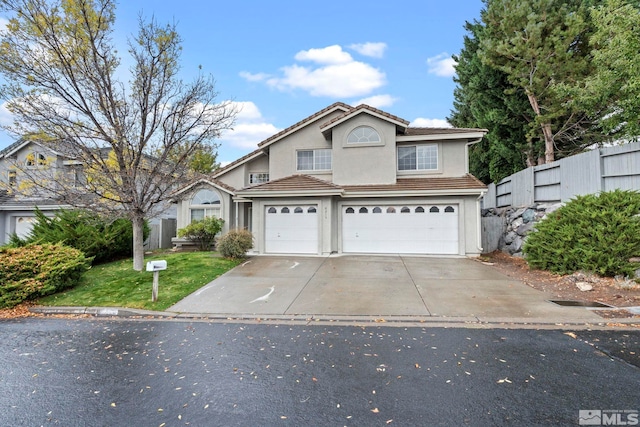 view of front property featuring a front yard and a garage