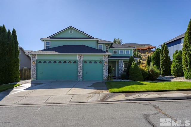 view of front of property featuring a front lawn and a garage