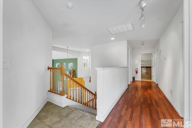 hall with lofted ceiling, a notable chandelier, and dark hardwood / wood-style floors