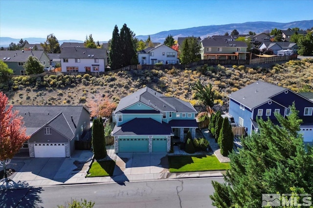 birds eye view of property featuring a mountain view