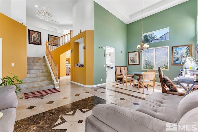 living room featuring a chandelier and a high ceiling