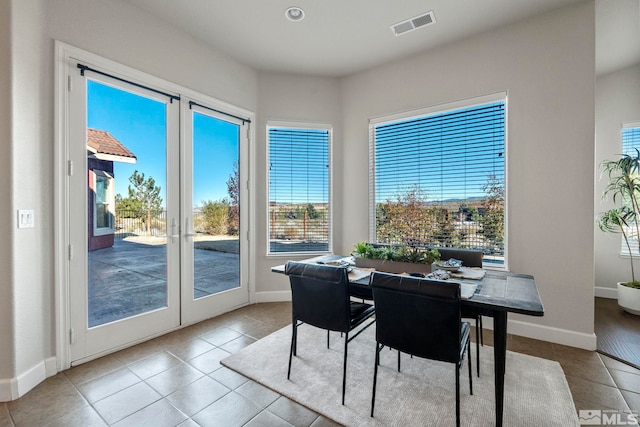 tiled dining area featuring plenty of natural light