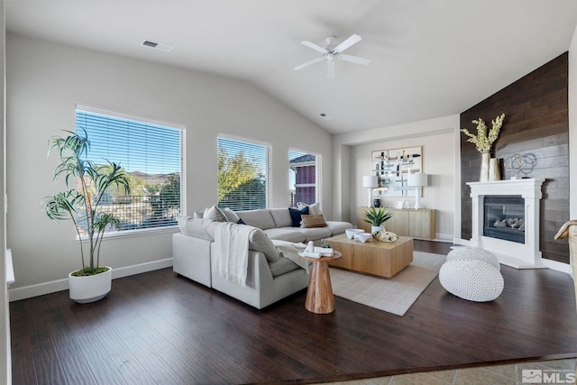 living room featuring vaulted ceiling, ceiling fan, and dark hardwood / wood-style flooring