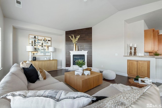 living room with wood walls, vaulted ceiling, and dark hardwood / wood-style flooring