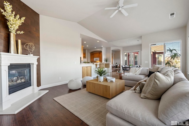 living room with vaulted ceiling, hardwood / wood-style flooring, and ceiling fan