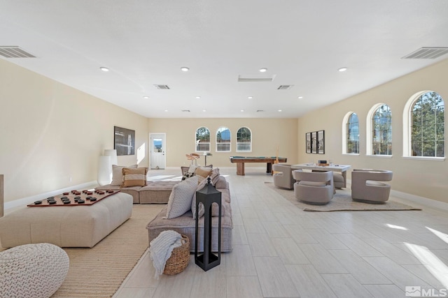 living room featuring billiards and a wealth of natural light