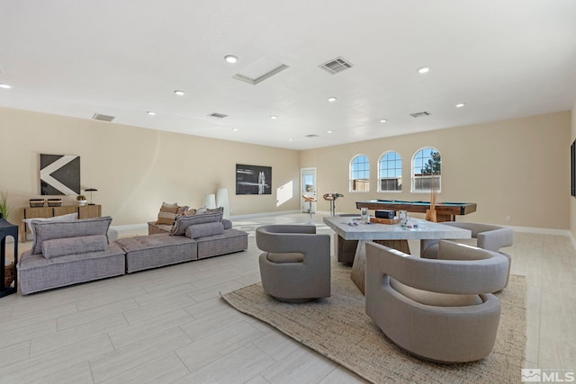 living room with pool table and light hardwood / wood-style floors