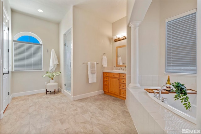 bathroom featuring vanity, independent shower and bath, and ornate columns