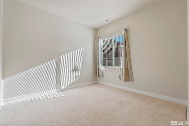 unfurnished room featuring light carpet