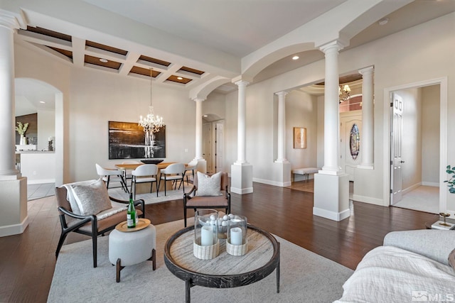 living room with beamed ceiling, dark wood-type flooring, coffered ceiling, and an inviting chandelier